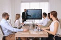 Business trainer using interactive board in meeting room during presentation Royalty Free Stock Photo