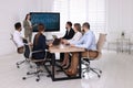 Business trainer using interactive board in meeting room during presentation