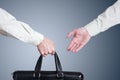 Business transfer deal. handover of a suitcase Royalty Free Stock Photo