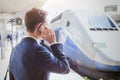 Business travel, businessman talking by phone at the railway station while waiting for the train Royalty Free Stock Photo