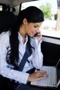 Business travel: businesswoman with laptop in car Royalty Free Stock Photo