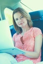 Business travel: busy businesswoman with laptop in car Royalty Free Stock Photo