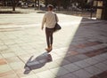 Business, travel and city with a young man walking outdoors against an urban background in the day. Entrepreneur or Royalty Free Stock Photo