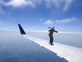 Business Travel Concept, Businessman Flying on Jet Plane Wing, Trip