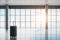 Business travel concept with hand suitcase in empty waiting area airport hall with glossy floor, columns and plane taking off Royalty Free Stock Photo