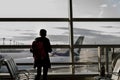 Business travel concept with silhouette man standing at gate in airport