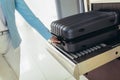 Travelers put baggage on X-ray machine try to detection metal prevention at the airport before take off Royalty Free Stock Photo