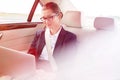 Businesswoman using laptop in car Royalty Free Stock Photo