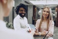 Business trip concept. Black man and caucasian woman businesspeople colleagues checking-in in hotel Royalty Free Stock Photo