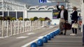 Business trip, man and woman hailing taxi near airport, transportation services