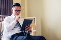 Businessman check tablet on hotel bed