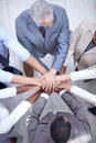 Business unity. a group of coworkers with their hands in a huddle.