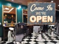 A business vintage sign that says `Come in We`re Open` on barber