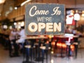 A business vintage sign that says `Come in We`re Open` on Cafe Royalty Free Stock Photo