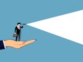 Business vision concept. businessman standing on hand. using telescope to look into the distance