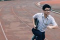 Business vision concept. Confident young Asian businessman with laptop ready run to forward on race track. Royalty Free Stock Photo