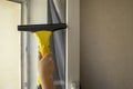 Business washing and cleaning windows. The yellow device collects drops of water and cleans the window. Hands wash the windows.