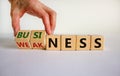 Business or weakness symbol. Businessman hand turns wooden cubes and changes the word `weakness` to `business`. Beautiful whit Royalty Free Stock Photo