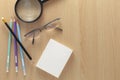 Business White paper note with pencils and glasses on wood table Royalty Free Stock Photo
