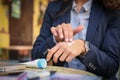 Business woman applying creme on hands at cafe. Close up Royalty Free Stock Photo