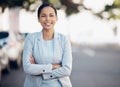 Business woman, arms crossed and confidence portrait in a city with a smile from worker. Young female person Royalty Free Stock Photo