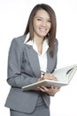 Business woman asian attractive standing using a pen writing diary or note book Royalty Free Stock Photo