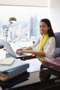 Business Woman Assistant Smiles At Camera Typing On PC Royalty Free Stock Photo