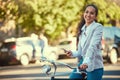 Business woman, bicycle and taking a mobile break outdoors in the street. Working lady in business travels with