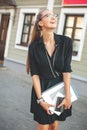 Business woman in black dress in the city with documents Royalty Free Stock Photo