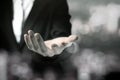 Business woman in black suit shows outstretched hand with bokeh black and white theme