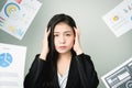 Business woman in a black suit is throw away a lot of paperwork and the documents are blown overhead.