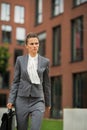 Business woman with briefcase walking in office Royalty Free Stock Photo