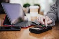 Business woman in cafe doing contact less payment, introducing secret number. digital tablet besides