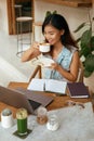 Business. Woman At Cafe Drinks Coffee. Laptop And Planner Book For Comfortable Digital Nomad Lifestyle Royalty Free Stock Photo