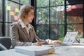 Business woman calculating monthly expenses, managing budget. Woman sitting at table using calculator to calculate tax Royalty Free Stock Photo