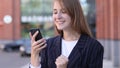 Business Woman Celebrating Success while Using Smartphone Royalty Free Stock Photo