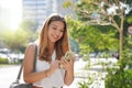 Business woman checking her mobile phone in Sao Paulo sustainable metropolis, Brazil