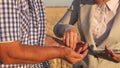 Business woman checks quality of grain in hands of farmer. close-up. business woman with tablet and farmer teamwork in Royalty Free Stock Photo