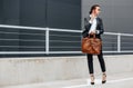 A business woman checks the time in the city during a working day waiting for a meeting. Discipline and timing. An employee goes