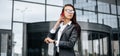 A business woman checks the time and talking on the phone in the city during a working day waiting for a meeting. Discipline and Royalty Free Stock Photo