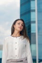 Business woman is on the city's business district smiling