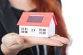 Business woman with close up of mini solar house Royalty Free Stock Photo