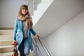 Business woman in coat walking down the stairs in the mall. Shopping. Fashion Royalty Free Stock Photo