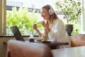 Business. Woman At Coffee Shop Having Online Meeting. Beautiful Model In Glasses Enjoying Summer Vacation And Working At Cafe Royalty Free Stock Photo