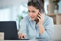 business woman with computer talking via cellphone