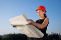 Business woman considers construction plans Royalty Free Stock Photo