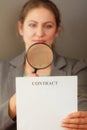 Business woman with contract and loupe Royalty Free Stock Photo