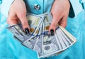 Business woman counting money in hands. Handful of money. Offering money. Women`s hands hold money denominations of 100 dollars. Royalty Free Stock Photo