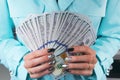 Business woman counting money in hands. Handful of money. Offering money. Women`s hands hold money denominations of 100 dollars. Royalty Free Stock Photo