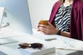 Business woman with cup of coffee at desk in minimalistic office Royalty Free Stock Photo